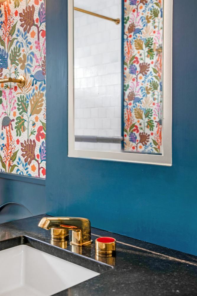 Blue vanity, floral wallpaper, brass