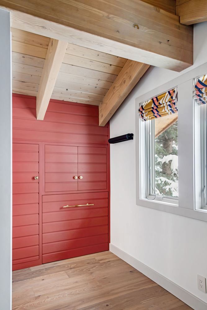 Bunk room in red, exposed rafters