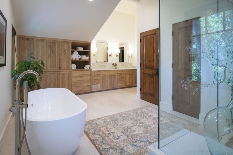 Primary bath with glass shower and oak vanity